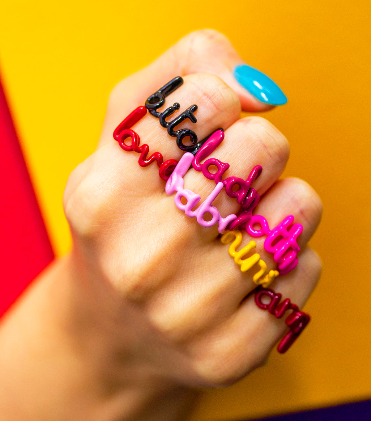 Hotlips by Solange written Hotscripts enamel and silver rings on hand