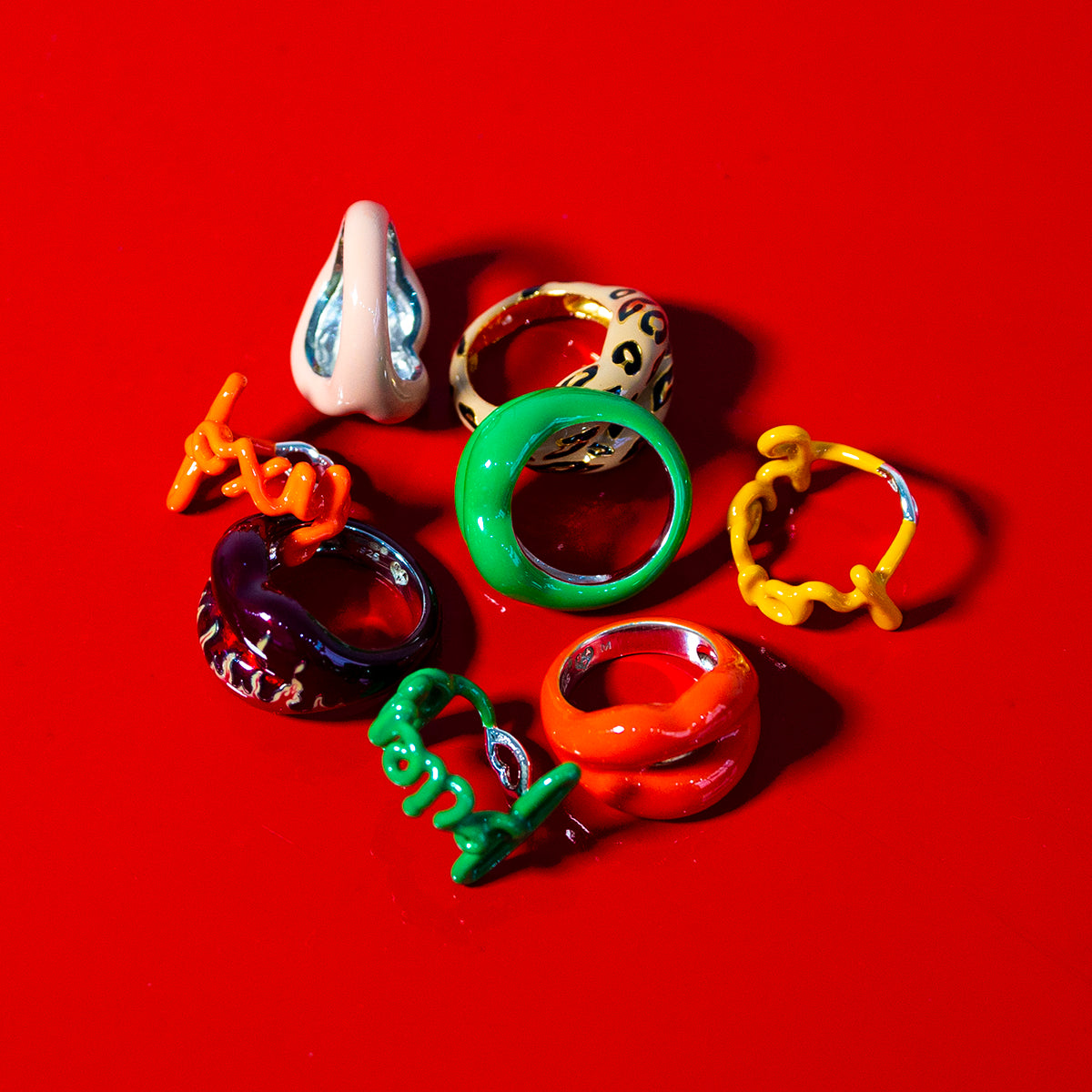 A pile of Hotlips and Hotscripts by Solange rings on a red background